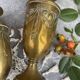 Pair of embossed brass bud vases stamped 17 cm