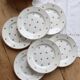 6 vintage flat plates from Nimy with red patterns.