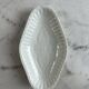 Oval white porcelain ramekin — raised floral pattern