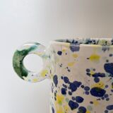 Green blue yellow speckled ceramic vase with abstract wool round handles