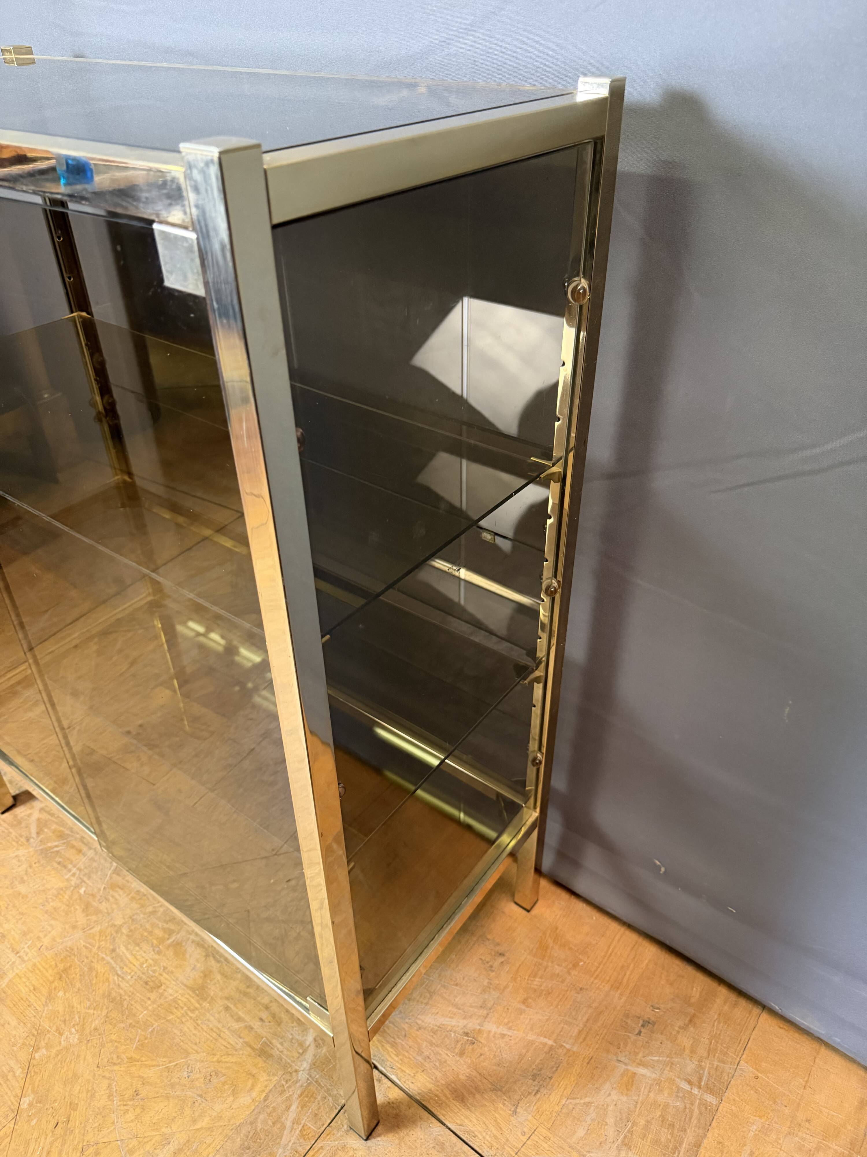 Chrome-plated brass display cabinet with smoked glass.