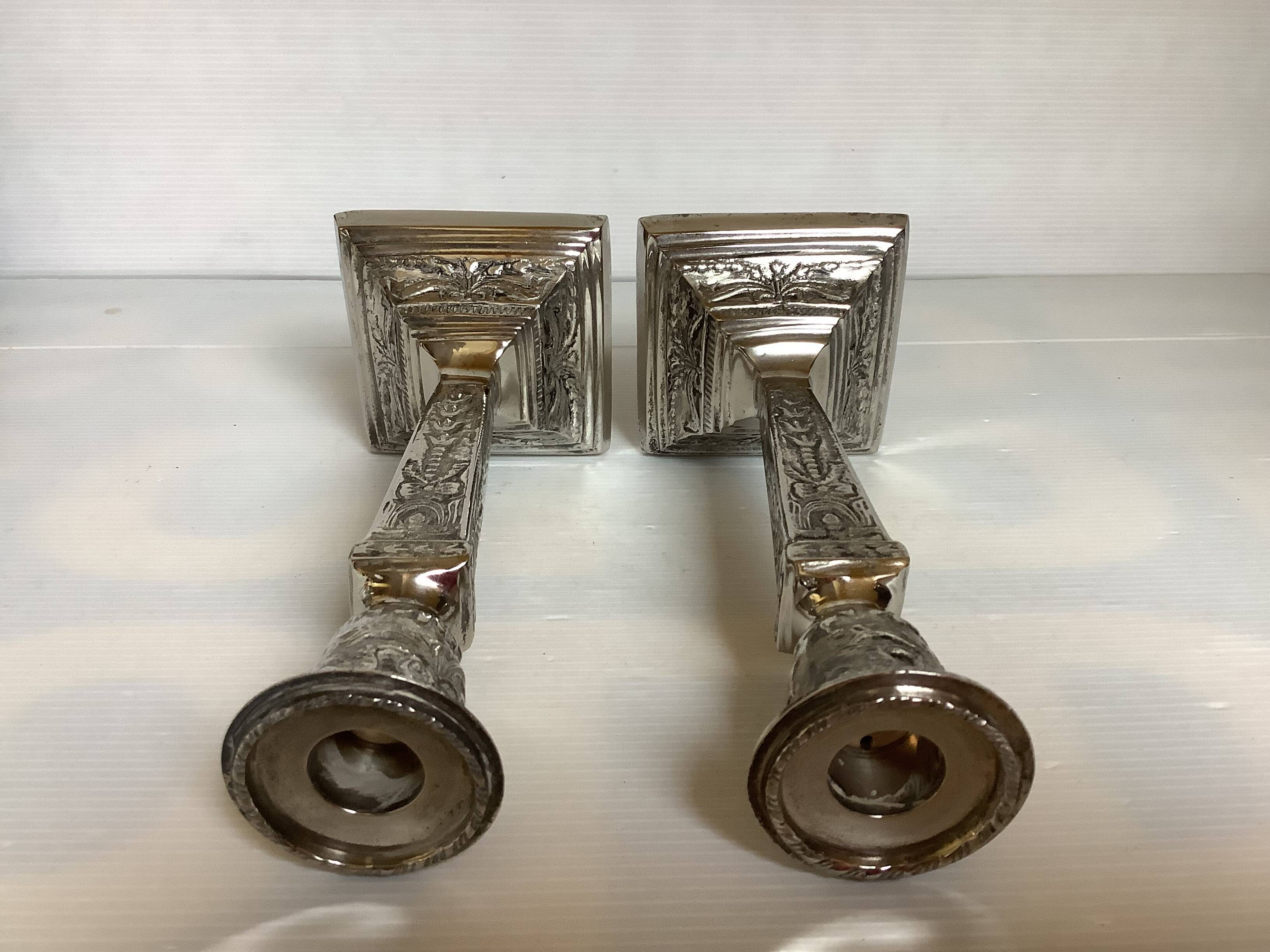 Pair of ornate silver candlesticks