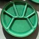 Many glazed stoneware plates with compartments.