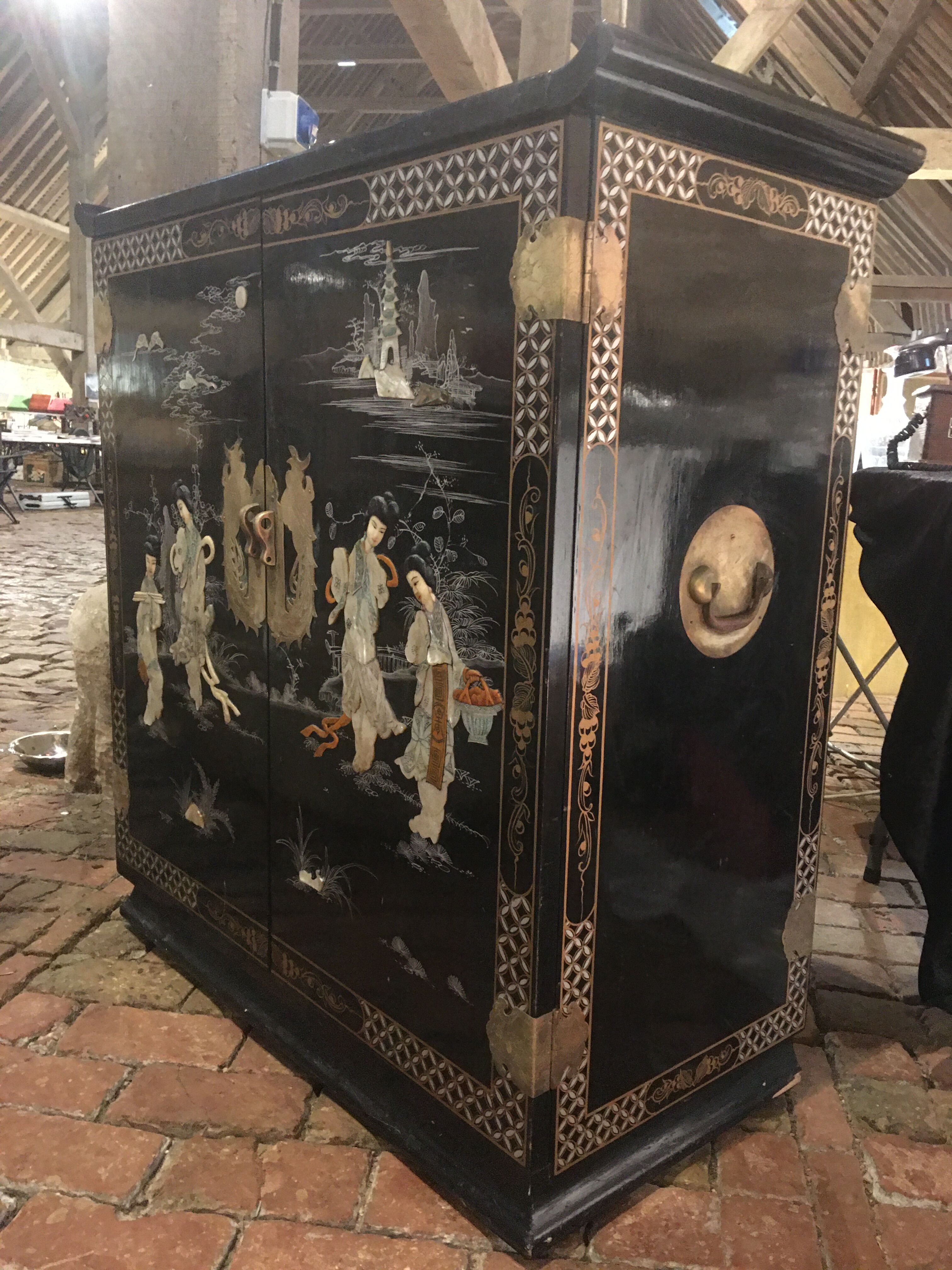 Asian lacquer cabinet with mother-of-pearl relief pattern