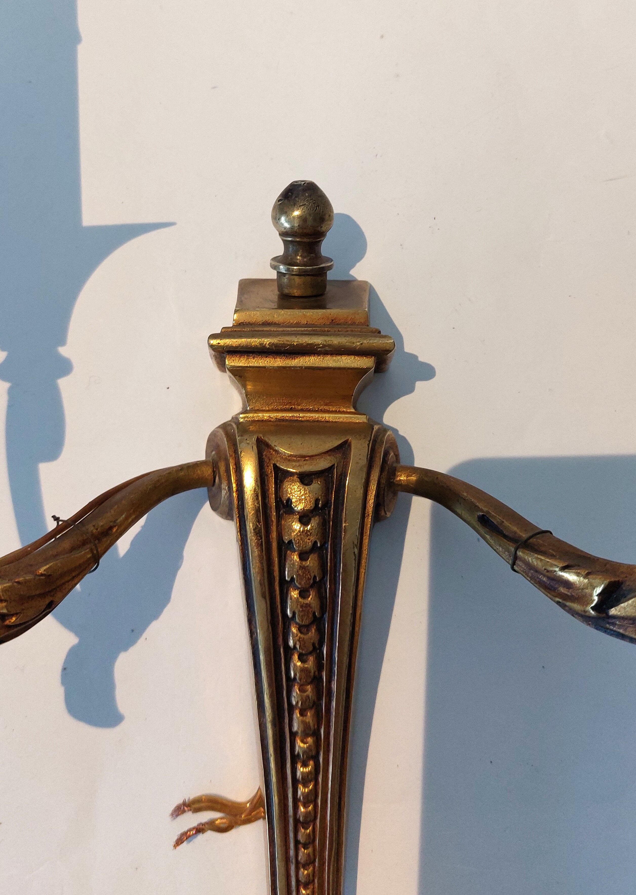 Pair of neoclassical sconces in bronze and gilded brass 1950.