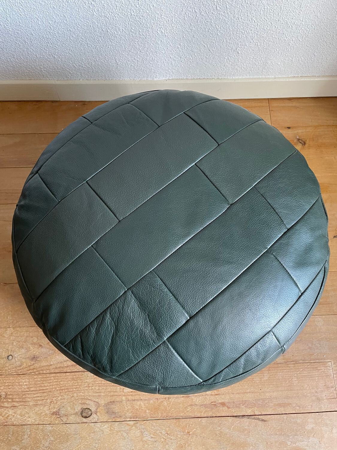Green patchwork leather pouf from Sède