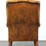 Sheepskin wingback chair with a unique design and a beautiful patina