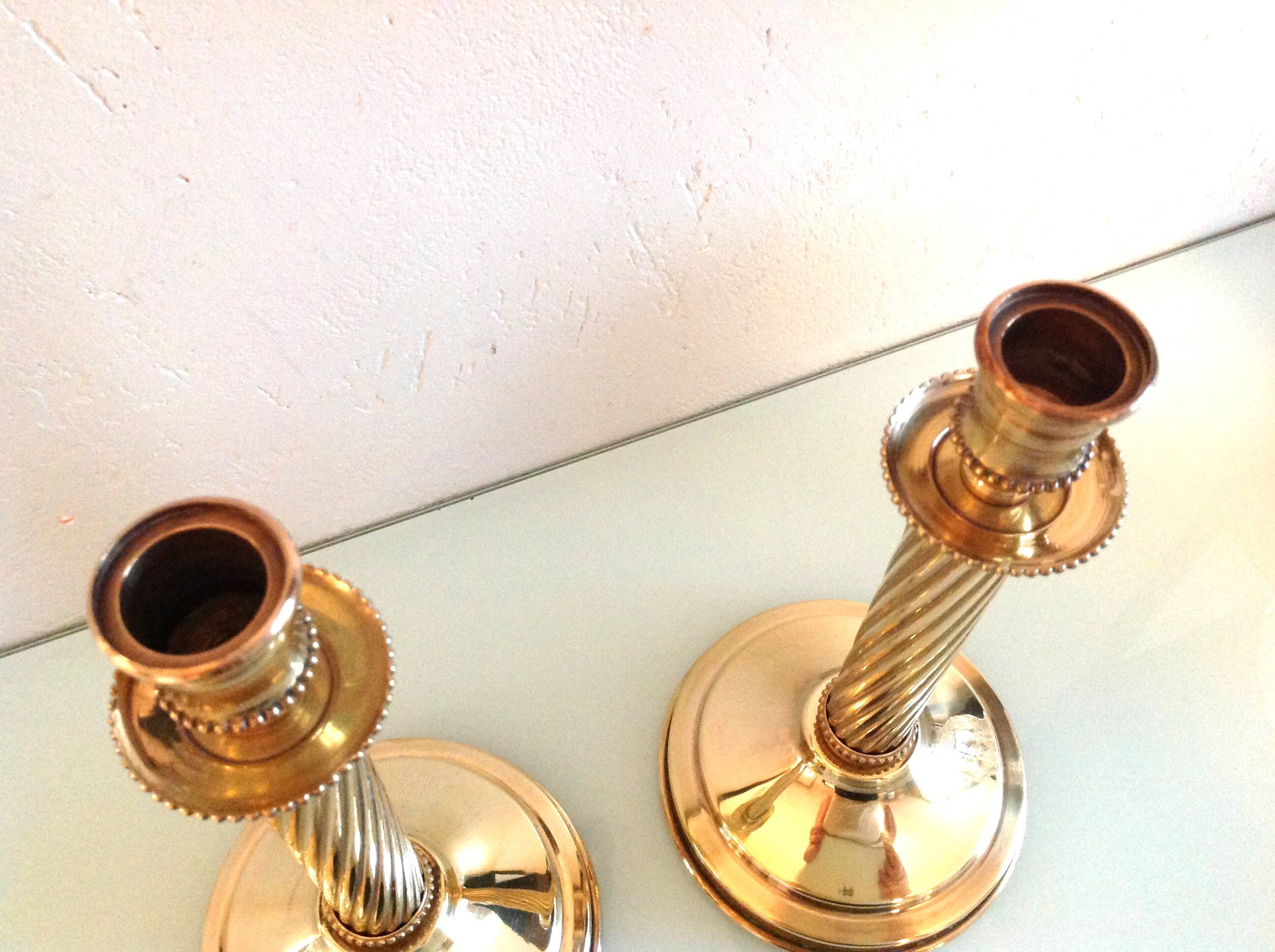 Pair of empire style brass candlesticks