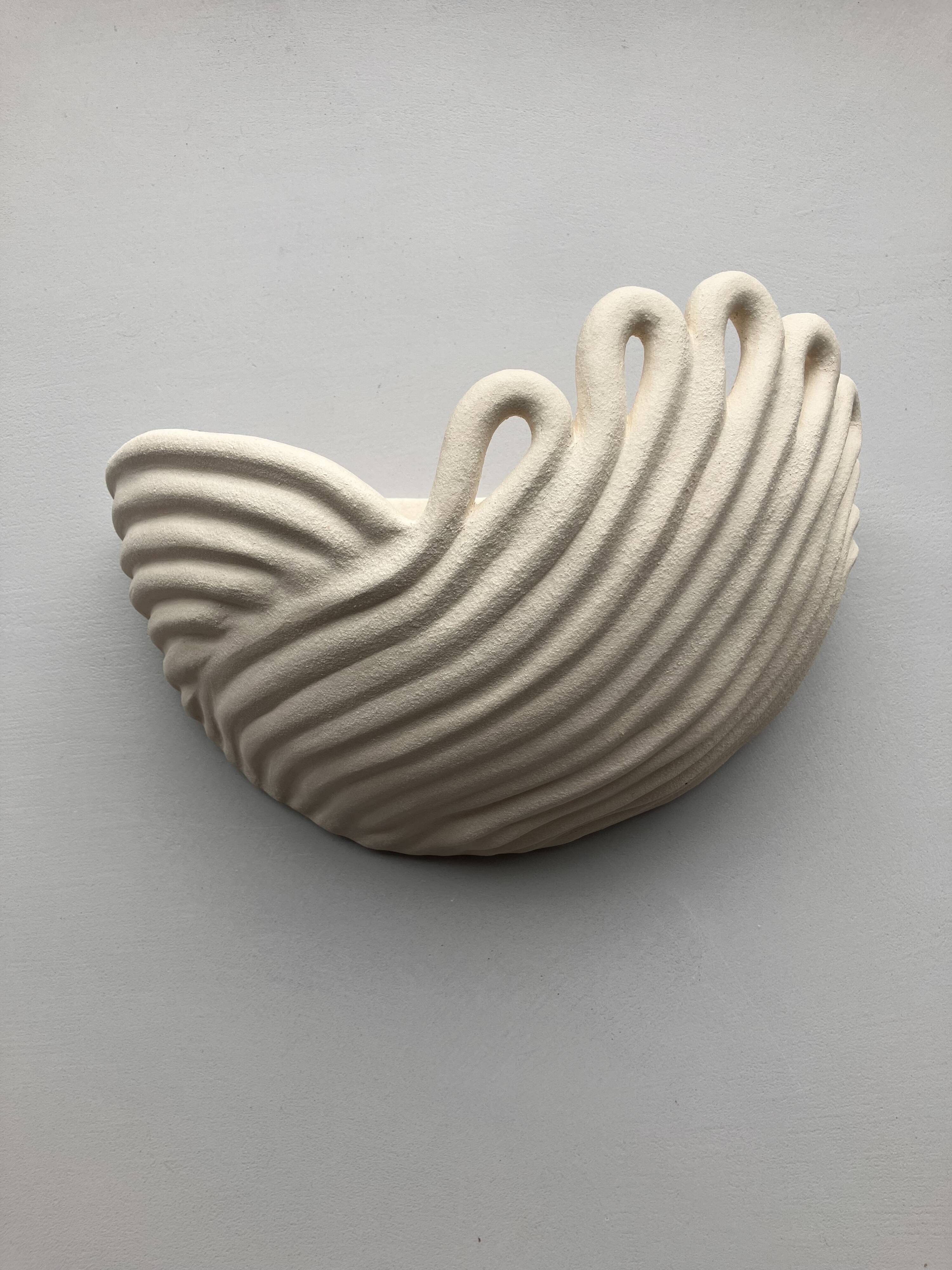 Draped ceramic wall light in a half-moon shape.