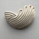 Draped ceramic wall light in a half-moon shape.