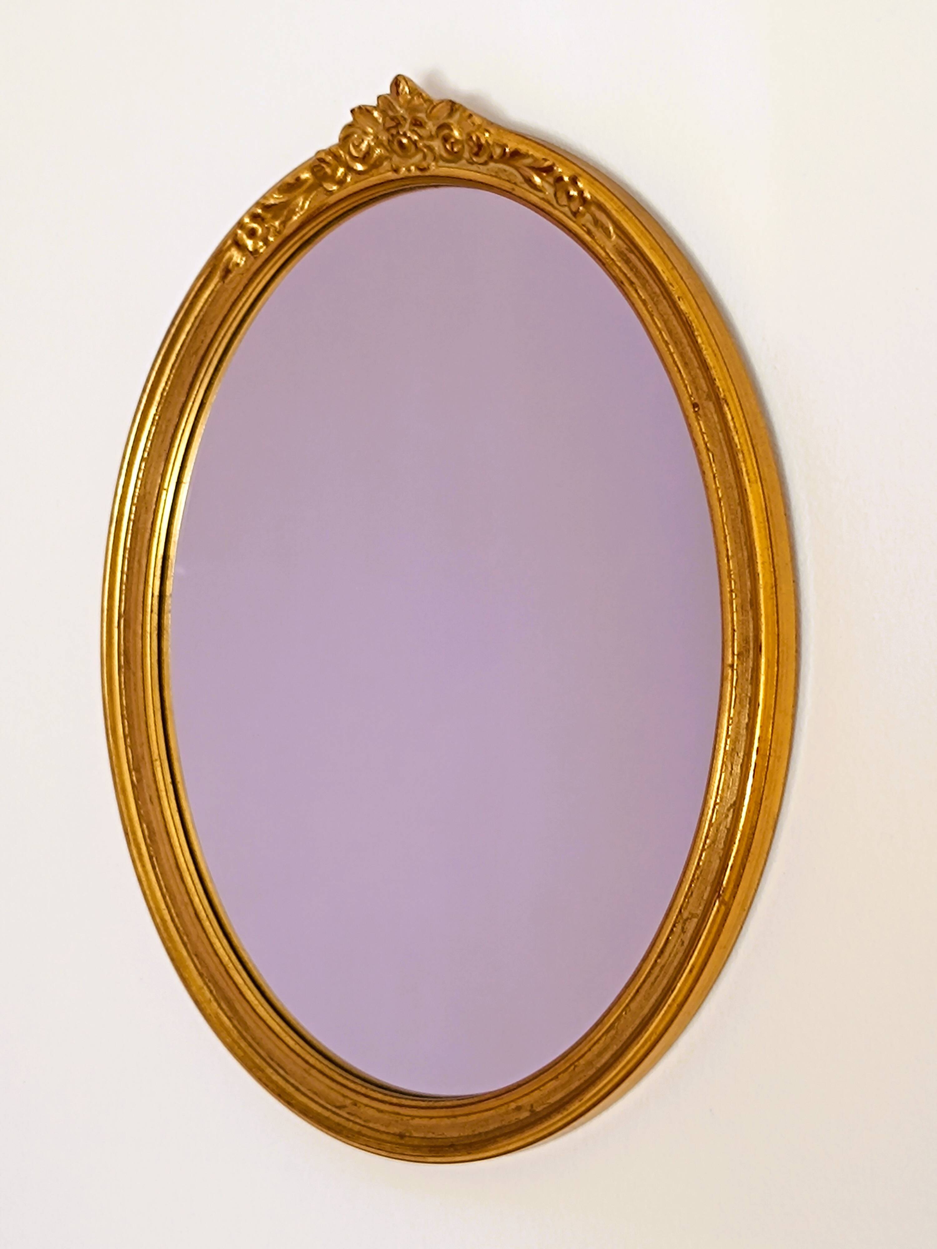 Antique oval-shaped gilded mirror