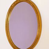 Antique oval-shaped gilded mirror