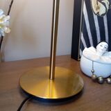 Table lamp with gold metal base and cylindrical textured glass shade