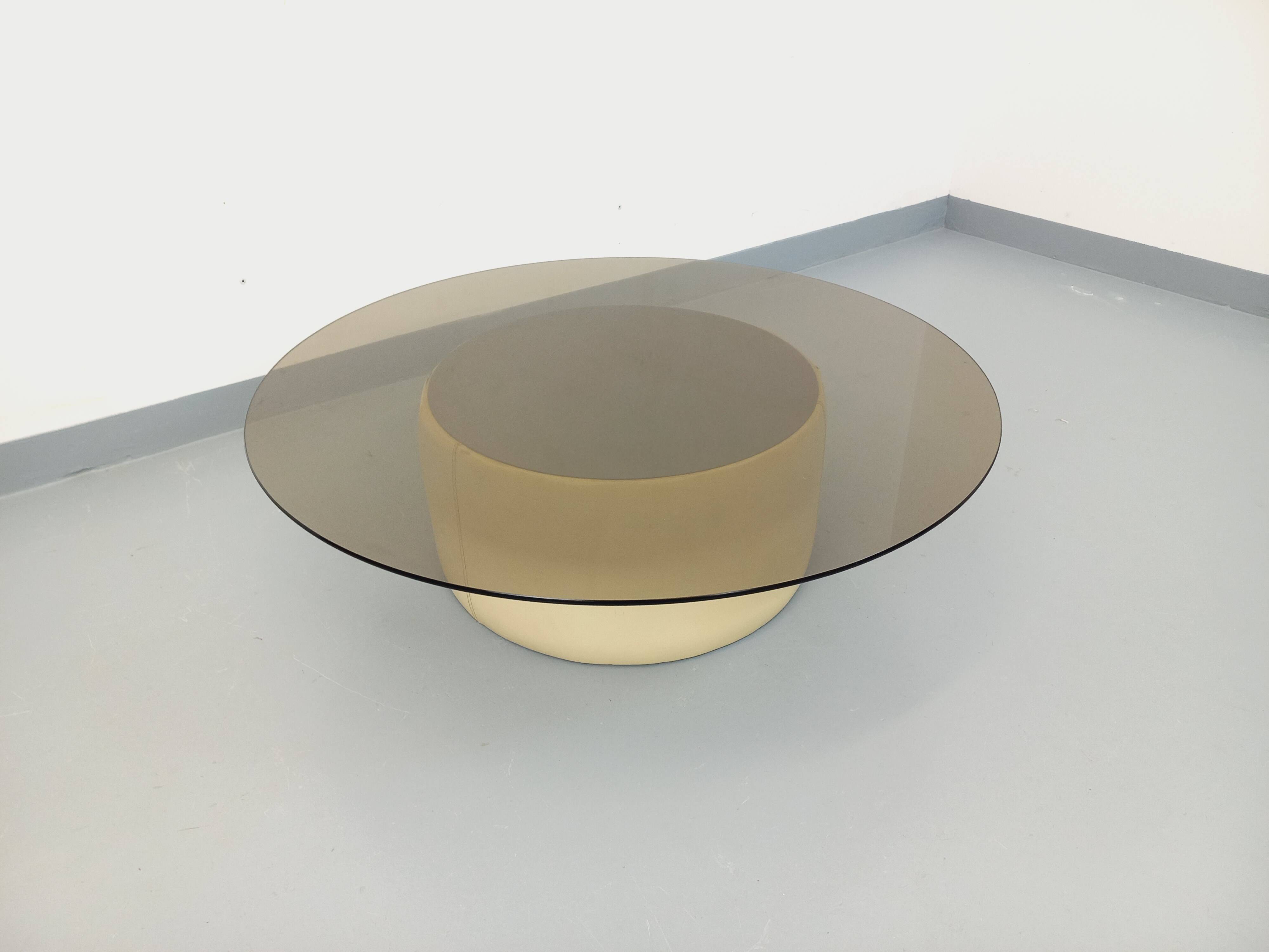 Vintage round coffee table in glass, leather, and metal in Space Age style from the 70s.