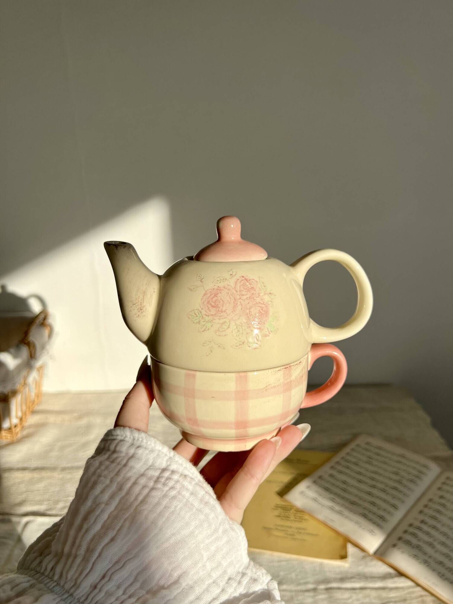 Vintage porcelain teapot and cup set with pink and beige floral and gingham pattern