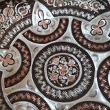 Oriental dish in chiseled red copper