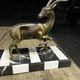 Bronze sculpture of a deer and doe in an Art Deco animal scene on a base.