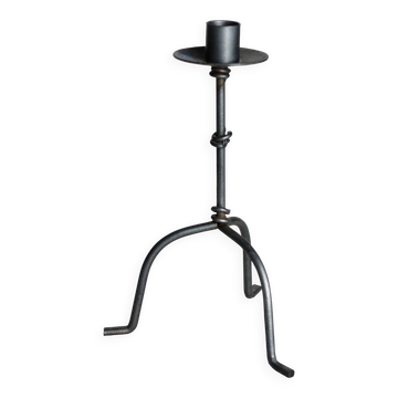 Antique tripod metal candlestick with knot decoration