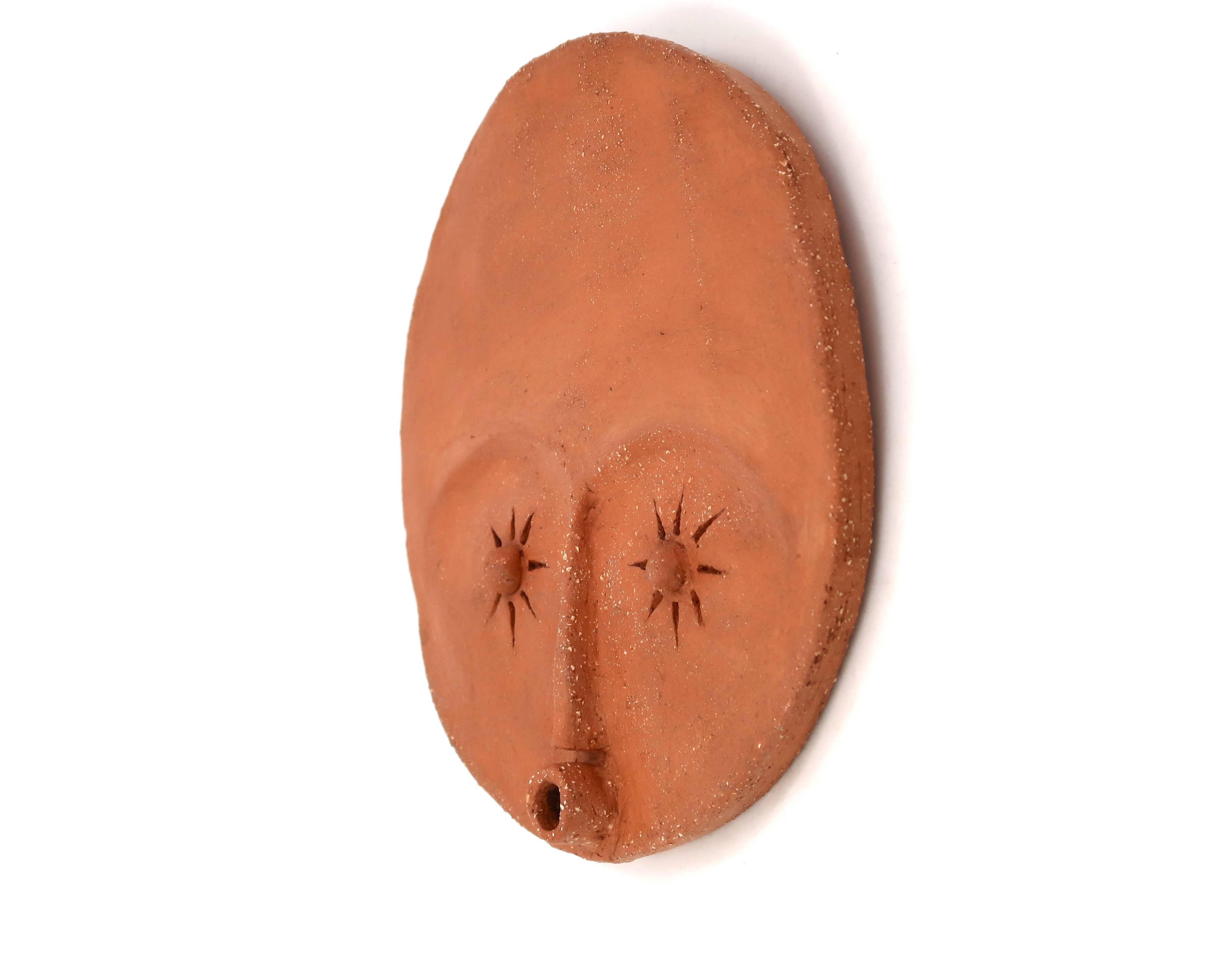 Round ceramic wall mask inspired by Africa, 1980s.