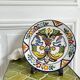 Decorative ceramic plate with griffins