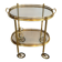 Small oval rolling table in brass with double removable trays from Maison Bagués.