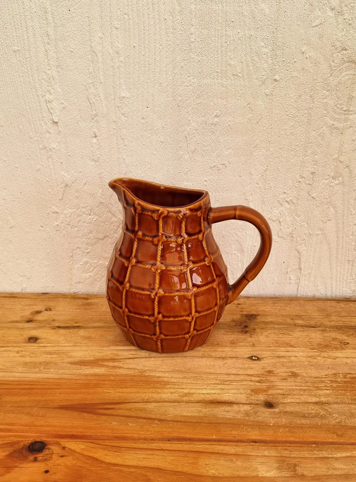 Vintage Saint Clément pitcher with a caramel checkered design.