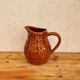 Vintage Saint Clément pitcher with a caramel checkered design.