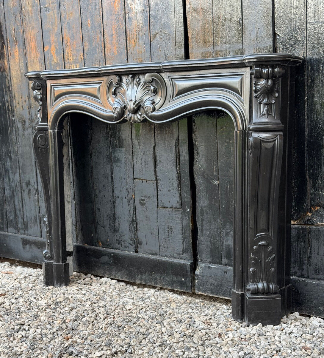 Louis XV style fireplace in black Belgian marble, circa 1880.