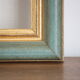 Frame in gilded and green wood