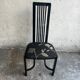 Set of 6 black lacquered wooden dining chairs with high backs and patterned fabric seats, 1980s.