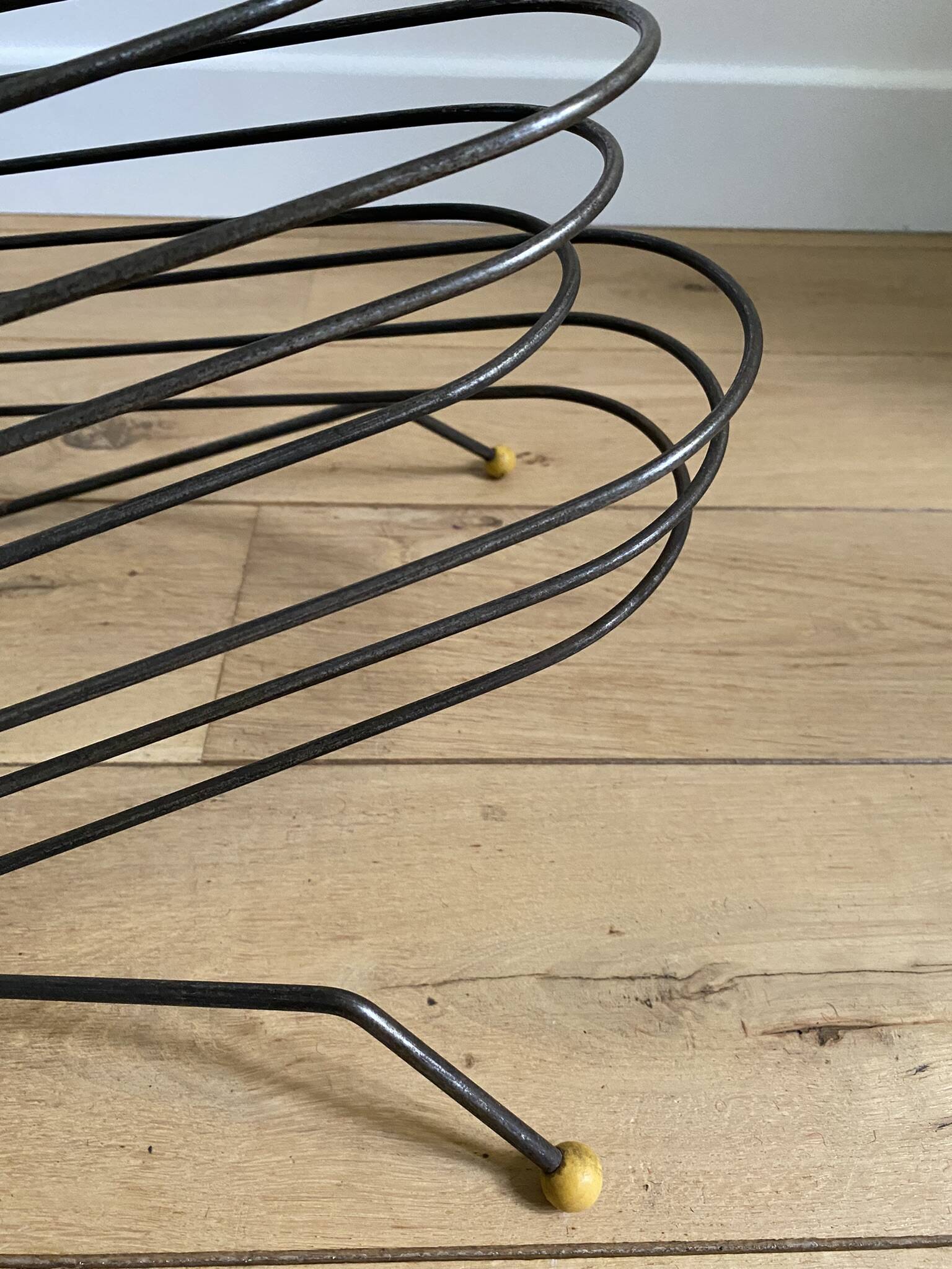 Black metal vinyl record holder and yellow scoubidou from the 60s