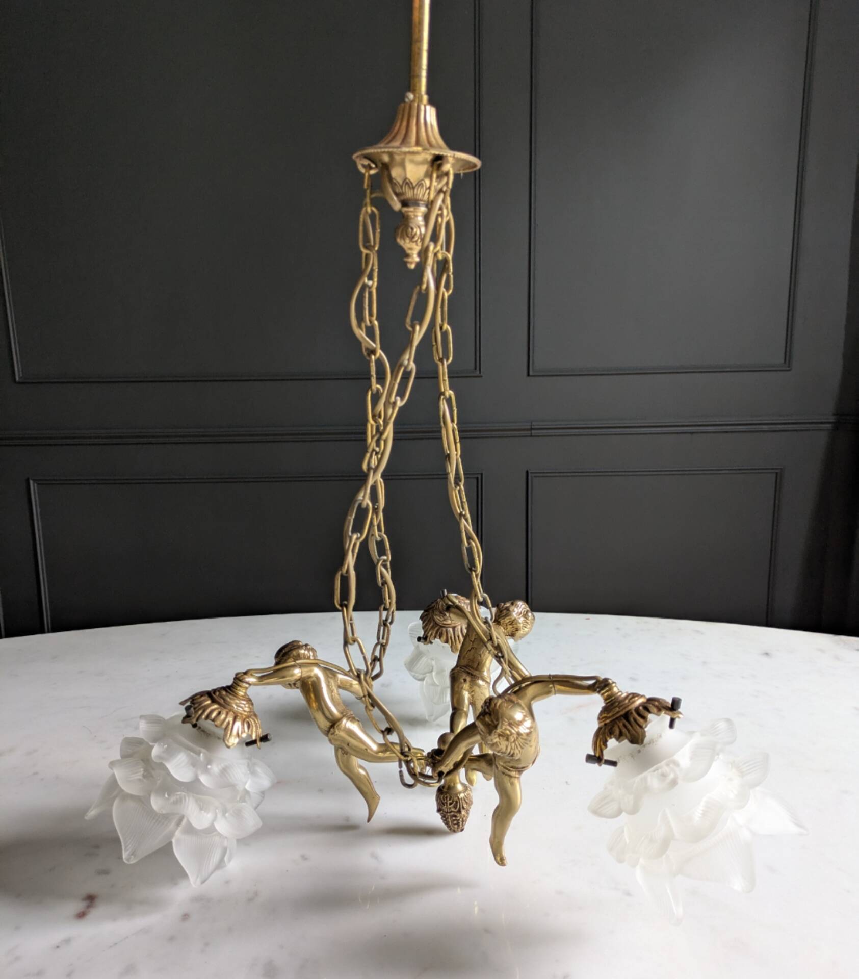 Vintage chandelier with cherubs and frosted glass flowers.