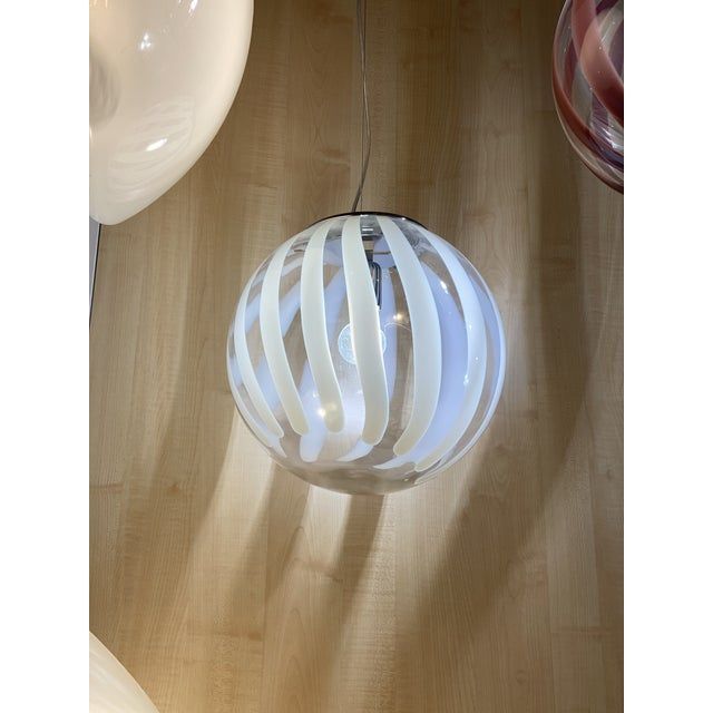 Contemporary transparent and white sphere pendant in murano glass