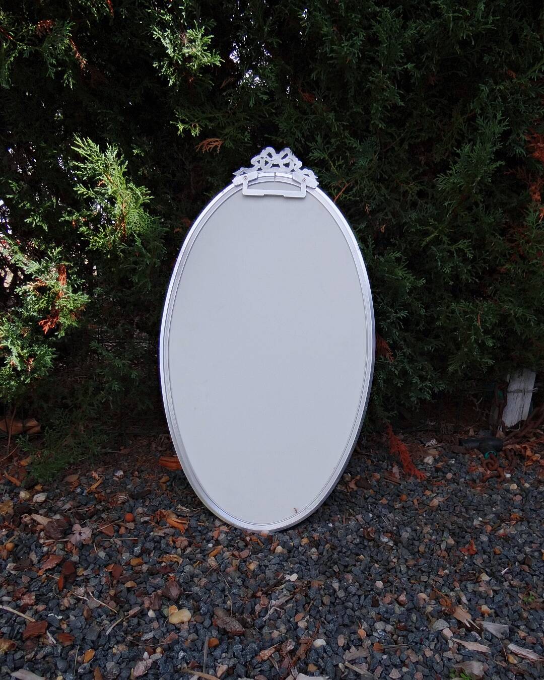 Oval mirror 66x37 Louis XVI style knot in vintage silver metal from the 70s