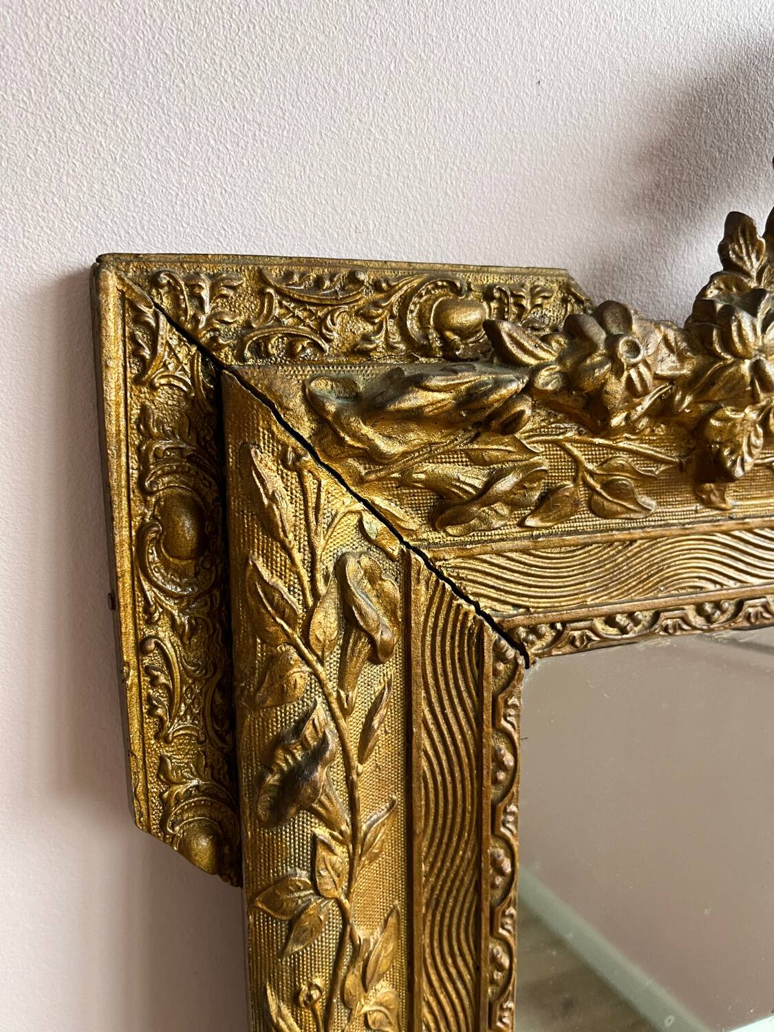 Golden trumeau mirror for fireplace, late 19th century, with sculpted pediment.