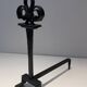 Important pair of wrought iron andirons with torch in heraldic fleur-de-lis design.