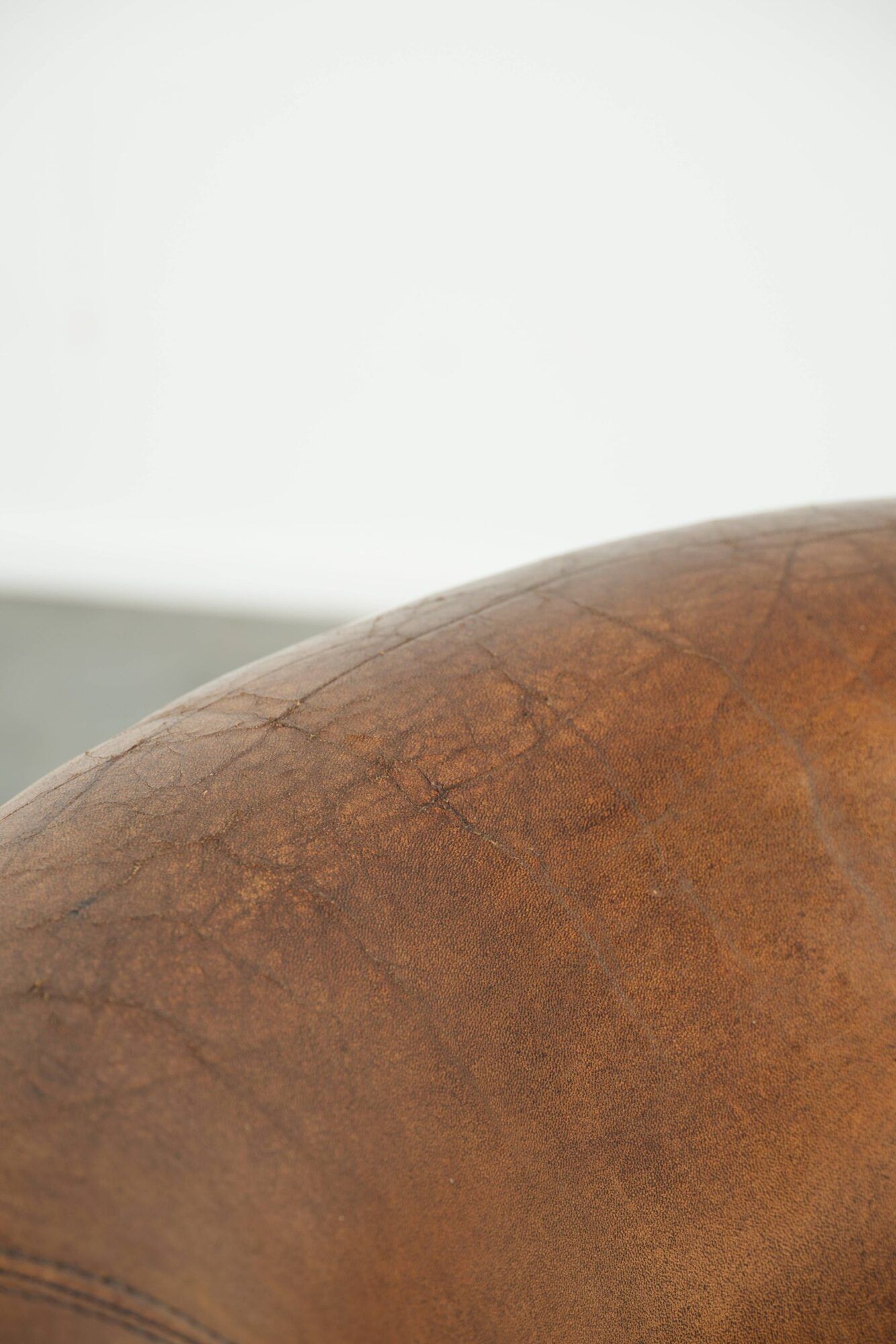 Sheepskin club armchair in a brown colour finished with decorative nails