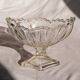 Oval glass fruit bowl on a stand.