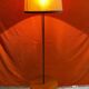 Vintage 1960s floor lamp with black tripod base and round varnished wooden shelf