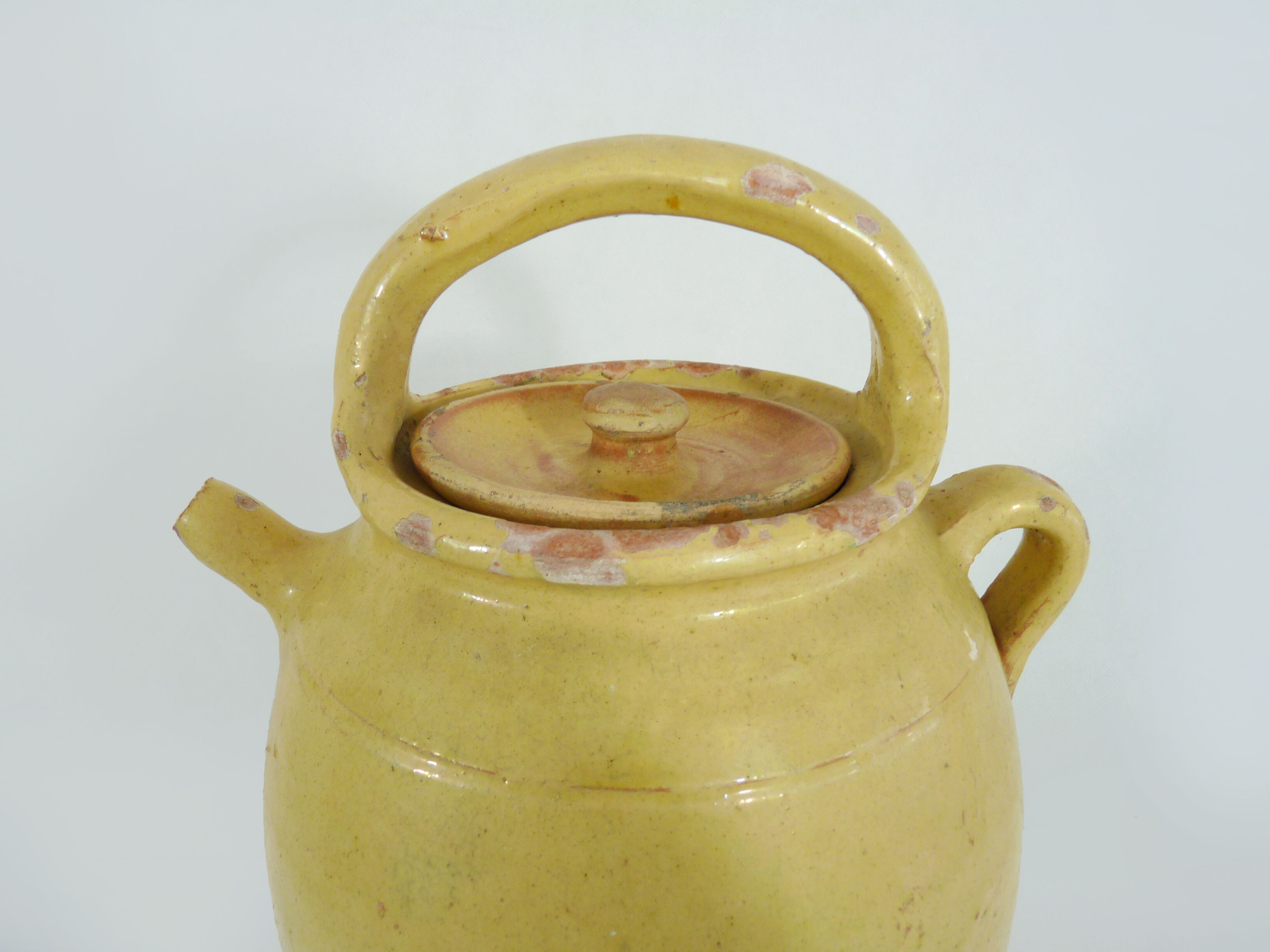 Old jug, chevrette, water pitcher in glazed yellow sandstone. Early twentieth century