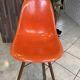 A vintage 70s Eames Herman Miller DSW Fiber Red Orange Dowel Walnut Chair