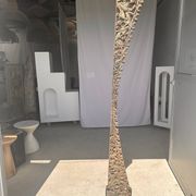Indonesian construction element in carved wood with intertwined plant motifs mounted on a base (fri