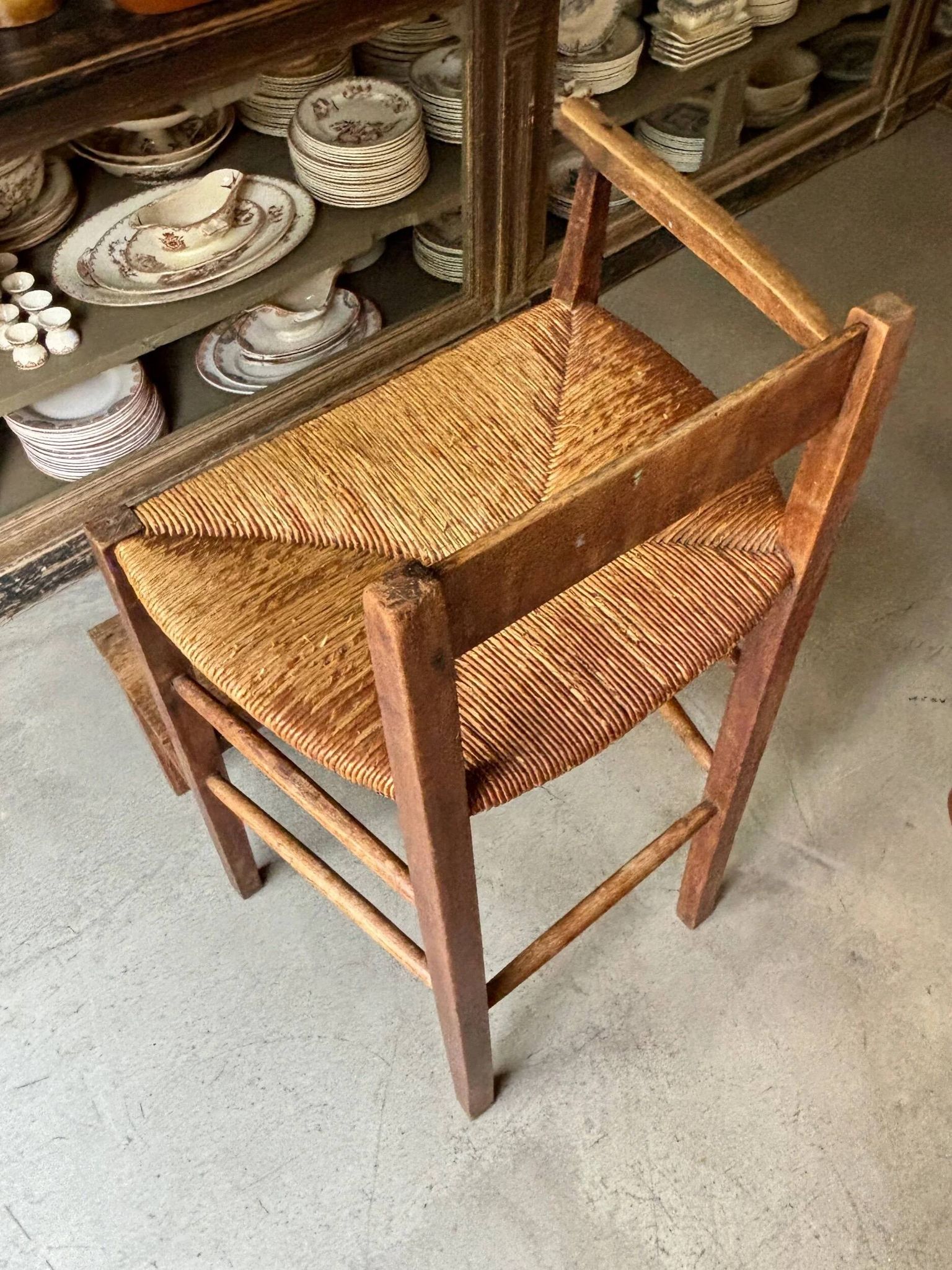 High chair made of wood and straw.
