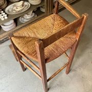 High chair made of wood and straw.