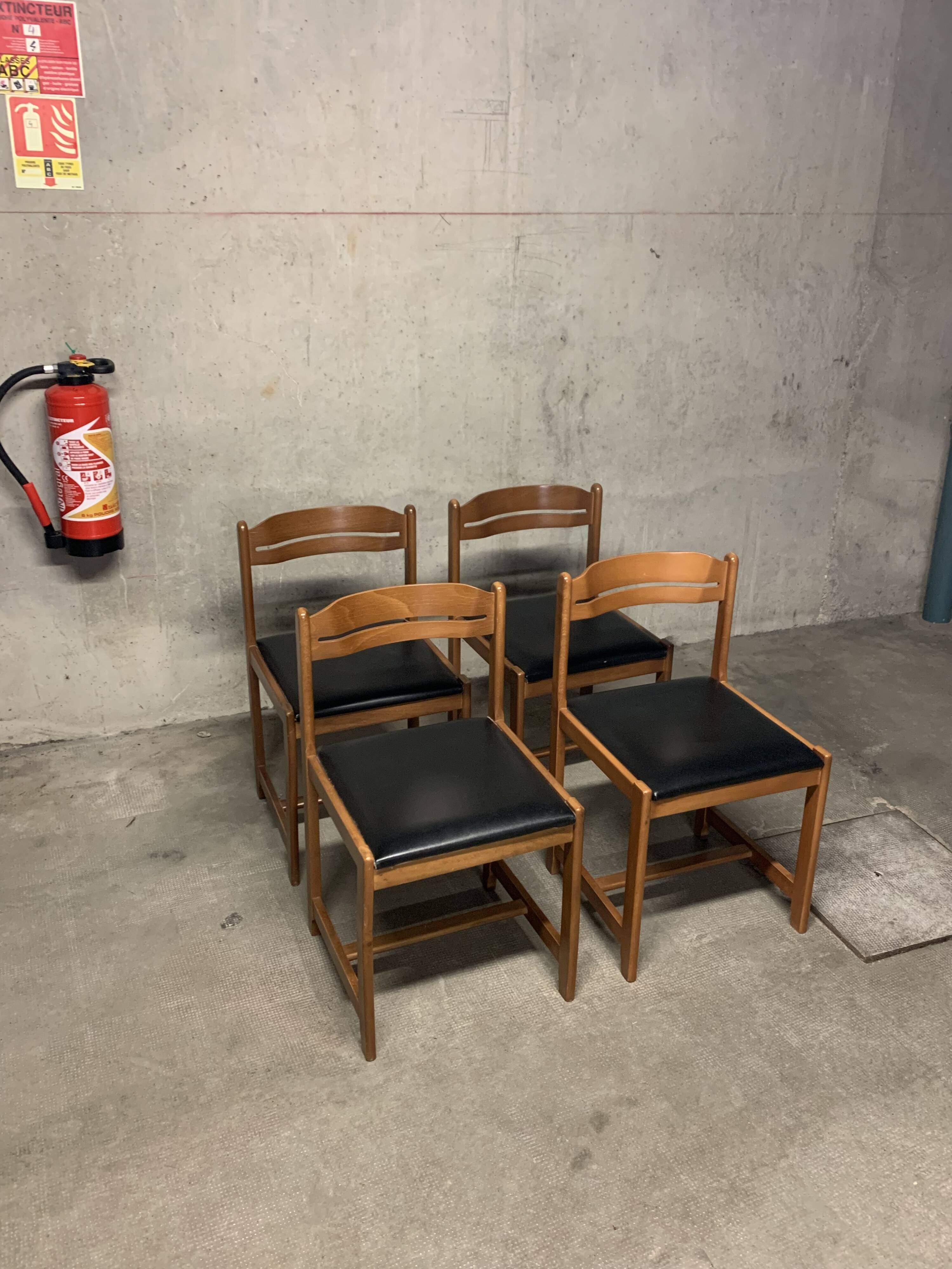 Set of four vintage chairs upholstered in retro design faux leather.