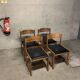 Set of four vintage chairs upholstered in retro design faux leather.