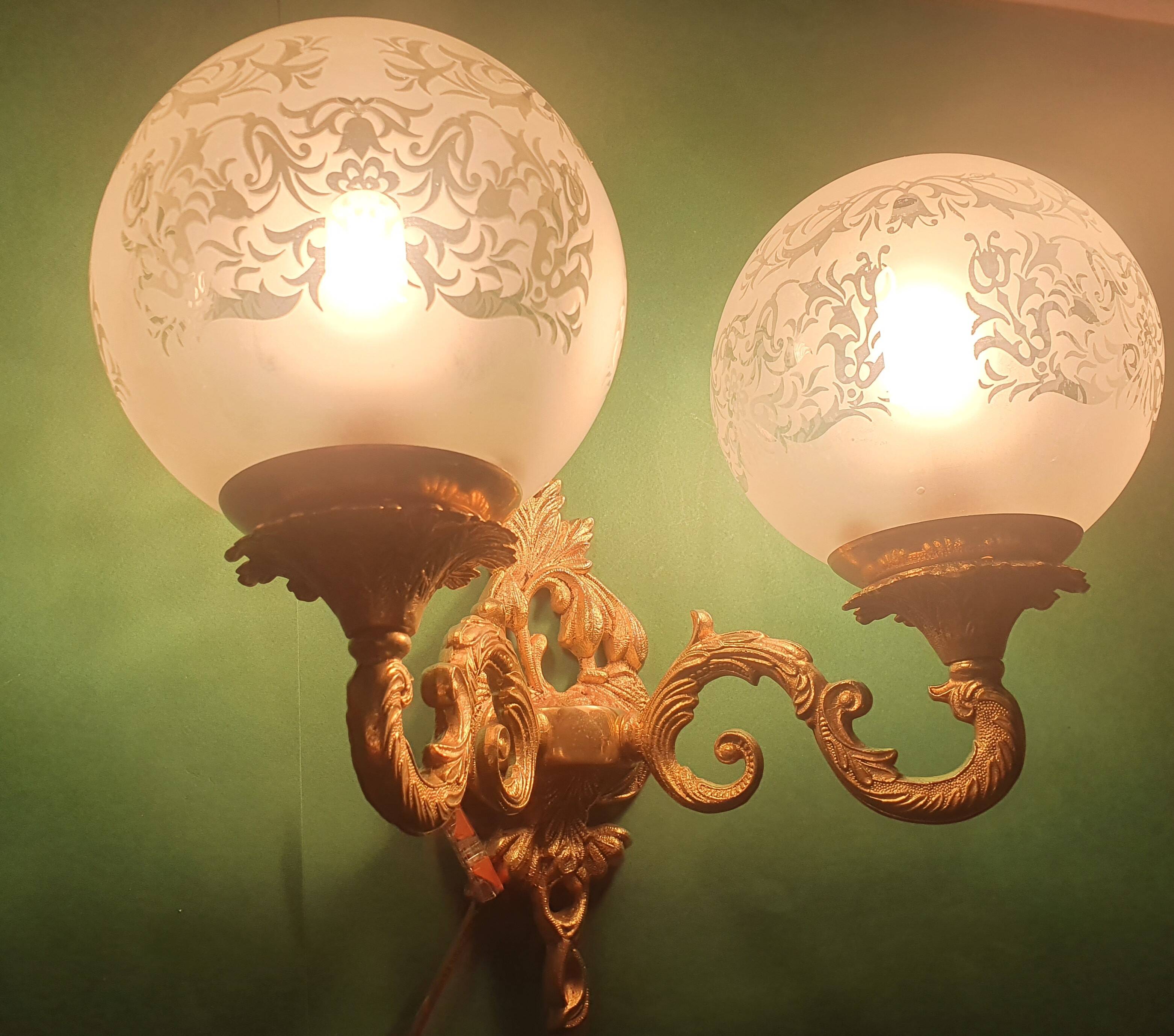 Pair of large double-light wall sconces in vintage brass and glass