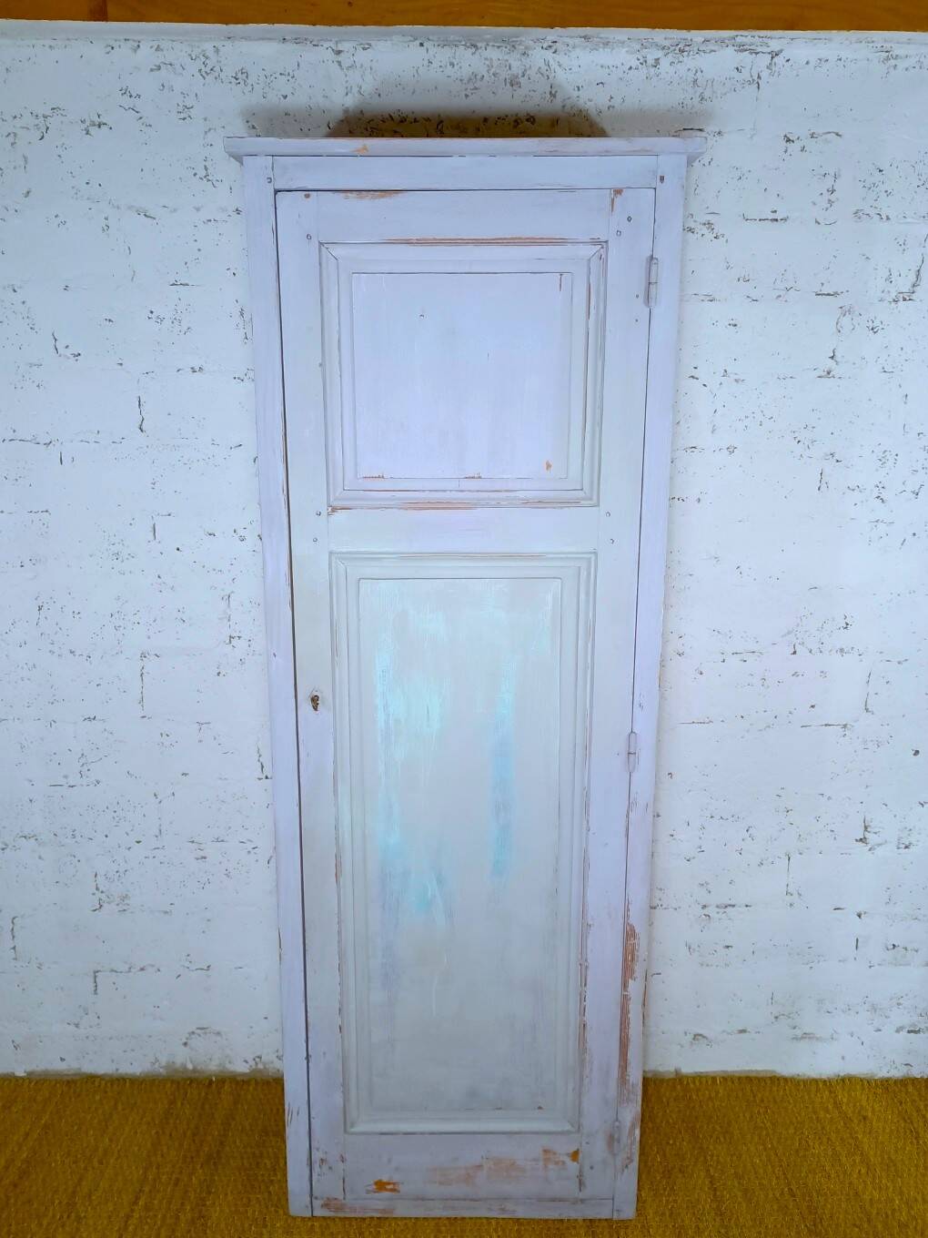 Rustic antique bonnetière in weathered blue-grey wood.