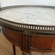 Louis XVI style bouillotte table in mahogany, white marble, and brass.