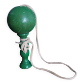 Old wooden painted green cup-and-ball toy
